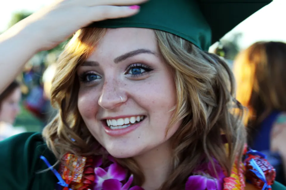 Smiling graduate at a convocation ceremony