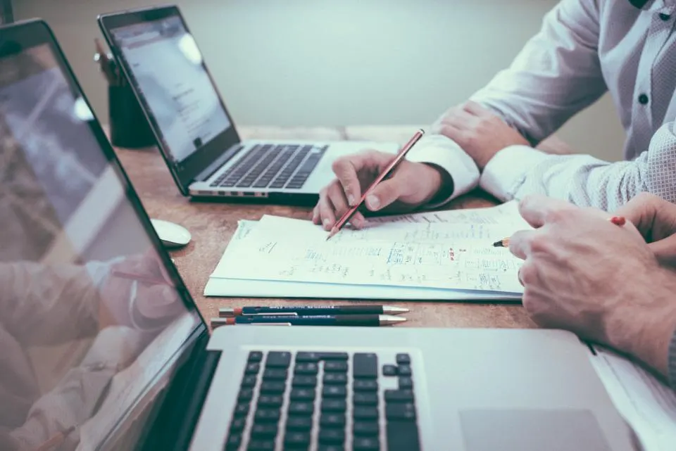 Professional managing accounts on a laptop